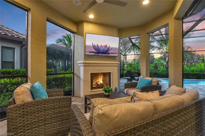 Patio terrace at dusk featuring an outdoor living space with a fireplace and ceiling fan