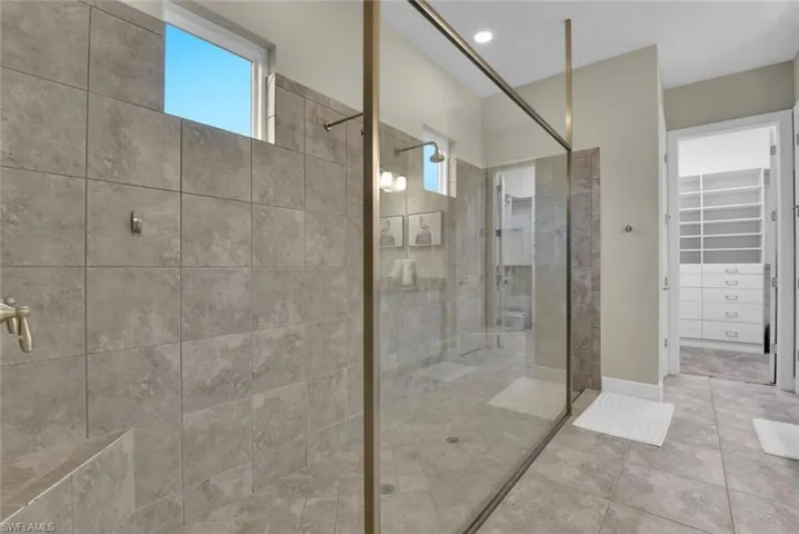 Bathroom featuring walk in shower and tile patterned floors
