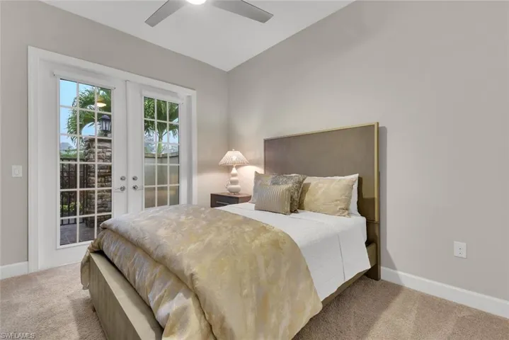Bedroom featuring french doors, access to exterior, ceiling fan, vaulted ceiling, and carpet