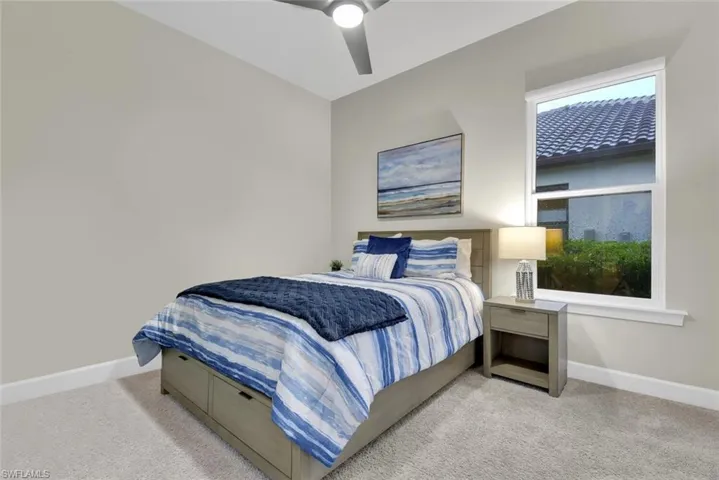 Carpeted bedroom with ceiling fan