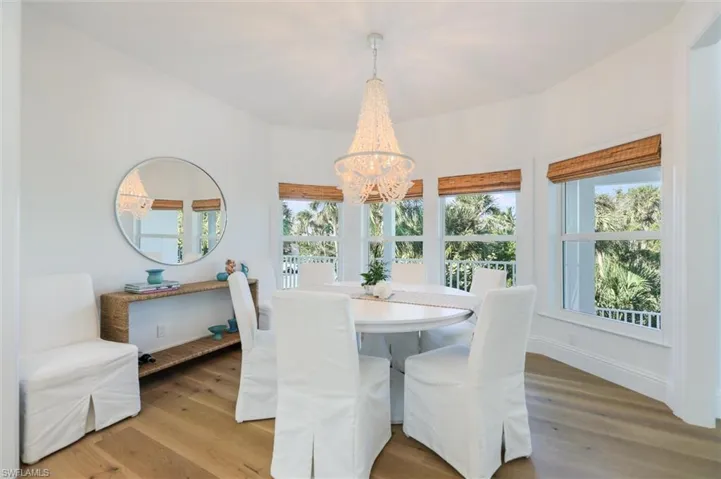 Dining space with hardwood / wood-style flooring and an inviting chandelier