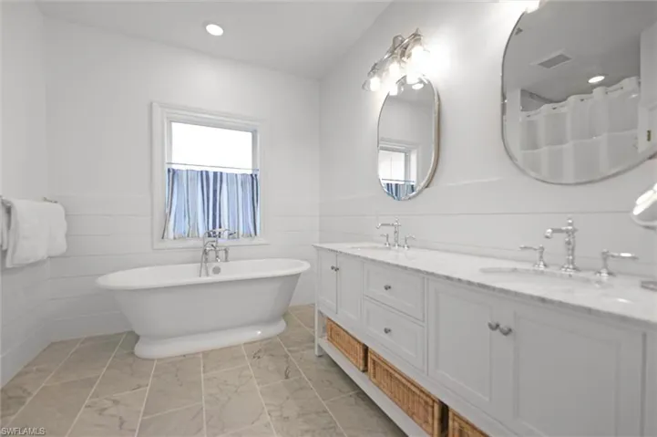 Bathroom with vanity and a tub to relax in