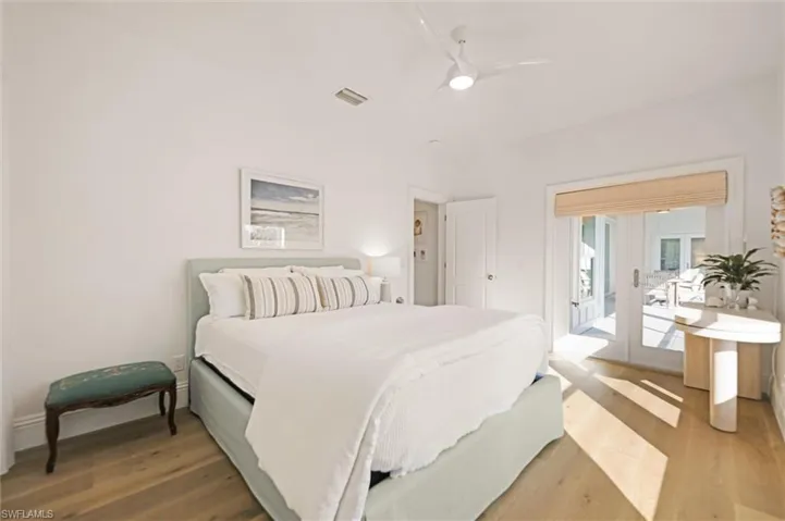 Bedroom with french door to exterior, ceiling fan, and engineered hardwood flooring