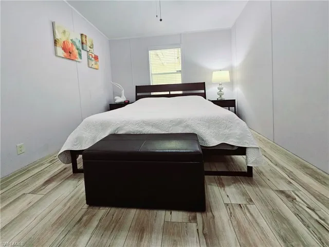 Bedroom featuring light wood-type flooring and a ceiling fan