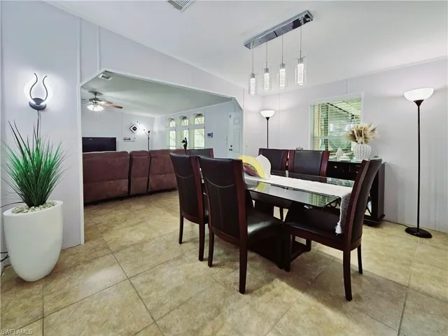 Dining area with ceiling fan and light tile patterned floors