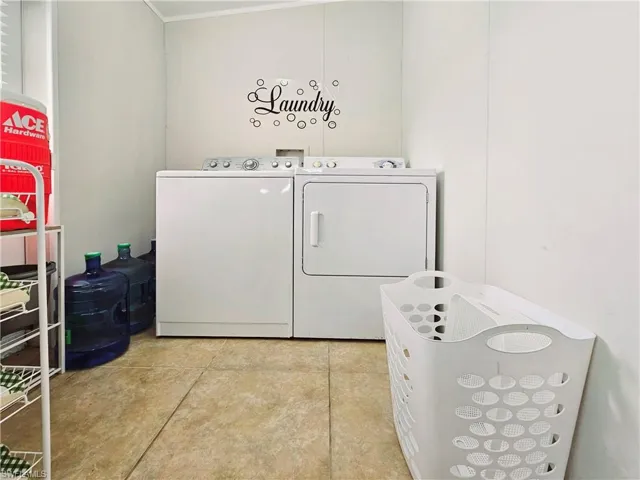 Washroom featuring light tile patterned floors and washer and dryer