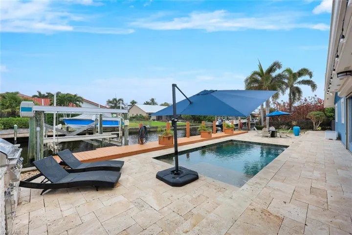 TWO HUGE boat lifts, travertine pavers AND a stunning pool!