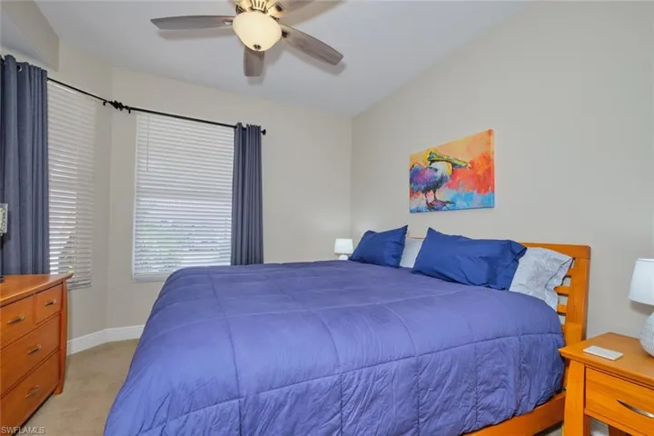 Bedroom featuring ceiling fan and light colored carpet