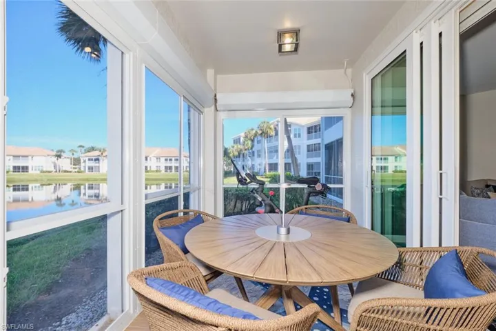 Sunroom / solarium with a water view