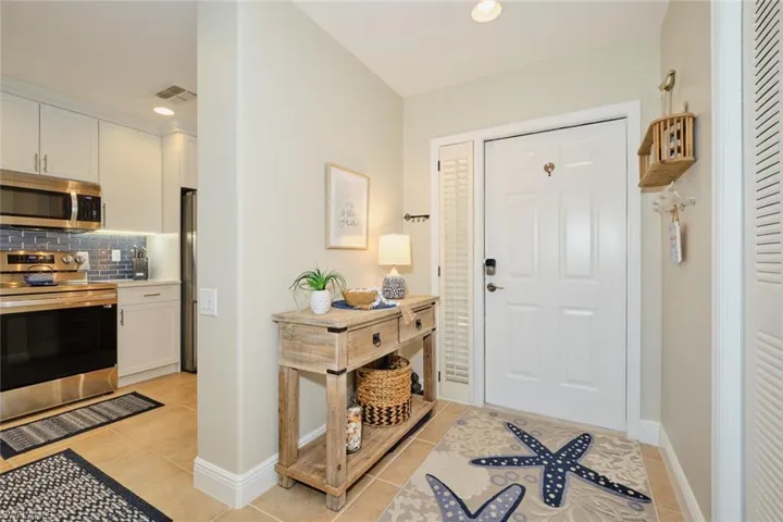 Foyer entrance featuring light tile patterned floors