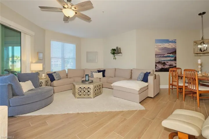 Living room featuring ceiling fan and light hardwood / wood-style floors