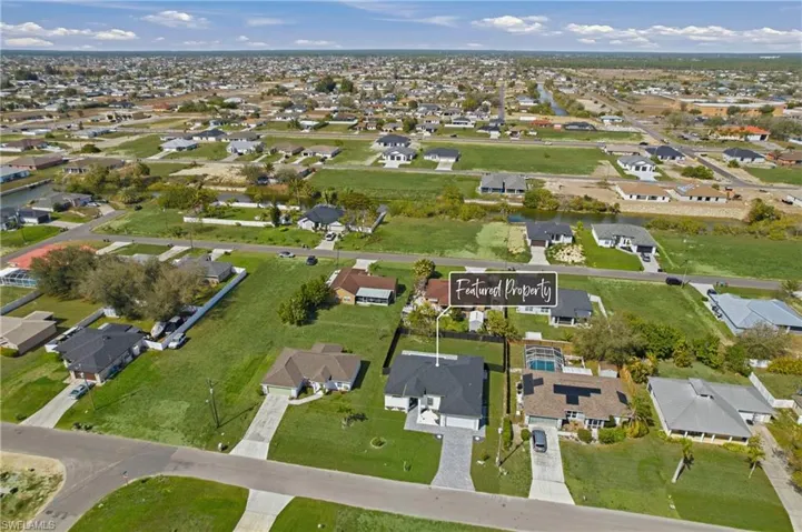 Aerial view of property's location featuring nearby suburban area