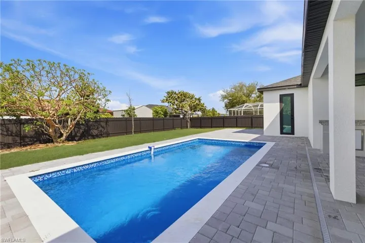 View of swimming pool with a fenced backyard and patio surround