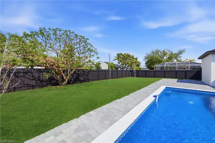 View of swimming pool with a fenced backyard and patio surround