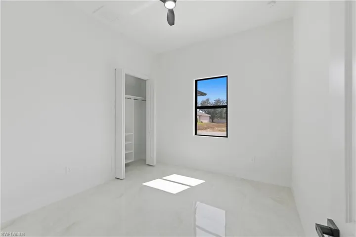 Unfurnished bedroom with a ceiling fan and baseboards