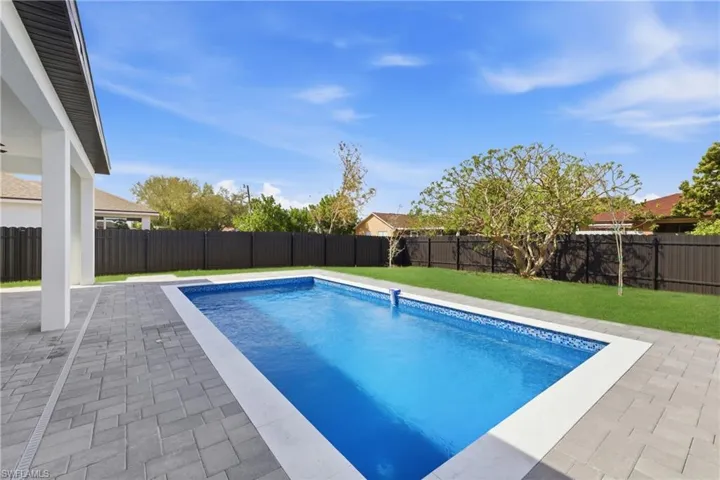 View of pool with a fenced backyard and patio surround