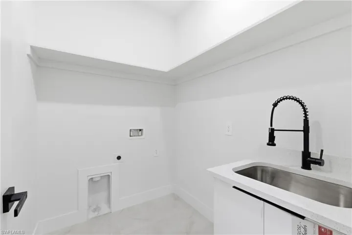 Laundry room featuring hookup for an electric dryer and hookup for a washing machine
