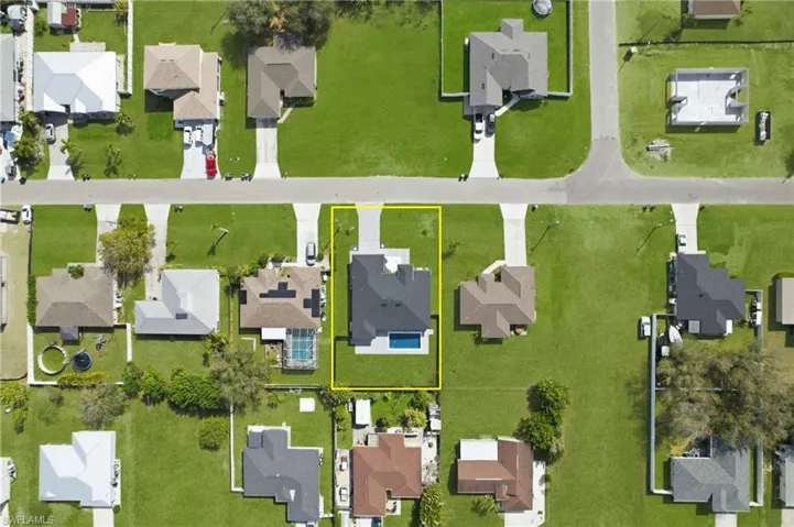 Aerial view of residential area with property boundaries highlighted