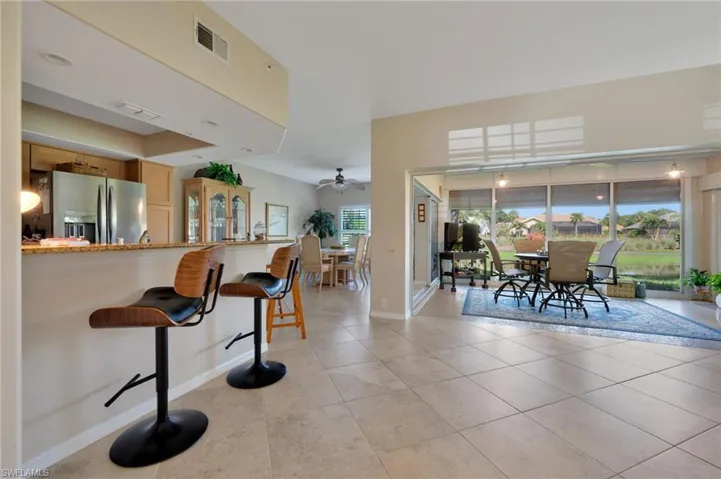 Dining space with ceiling fan and light tile floors