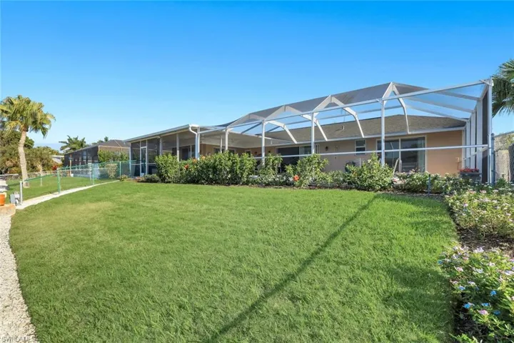 View of yard with a sunroom and glass enclosure