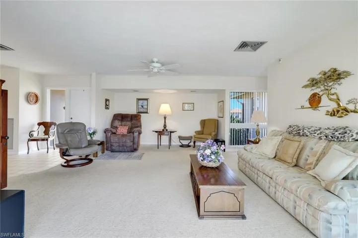Living room with a ceiling fan and carpet