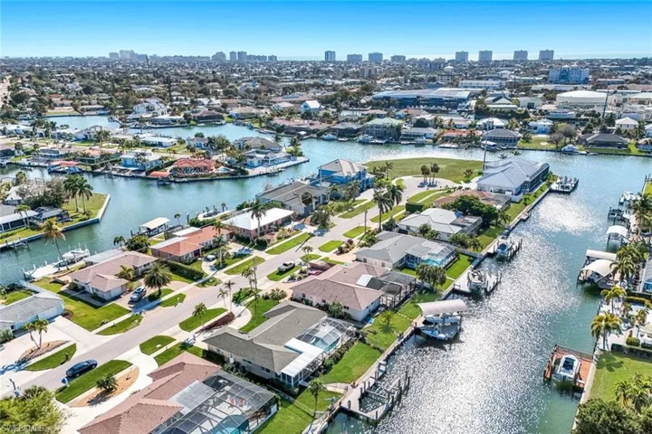 Aerial overview of property's location featuring a large body of water and nearby suburban area