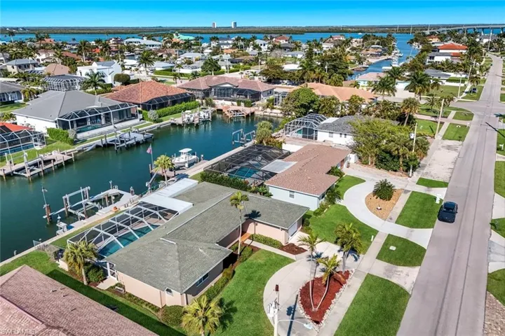 Aerial perspective of suburban area featuring a large body of water