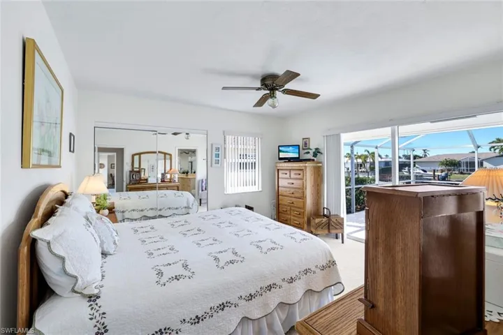 Bedroom with ceiling fan, access to outside, and a closet