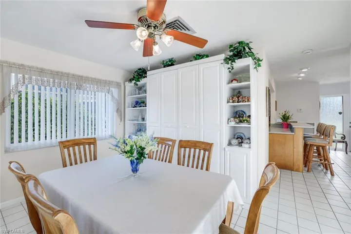 Dining space featuring light tile patterned floors and a ceiling fan