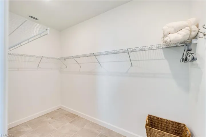 Walk in closet featuring light tile patterned floors