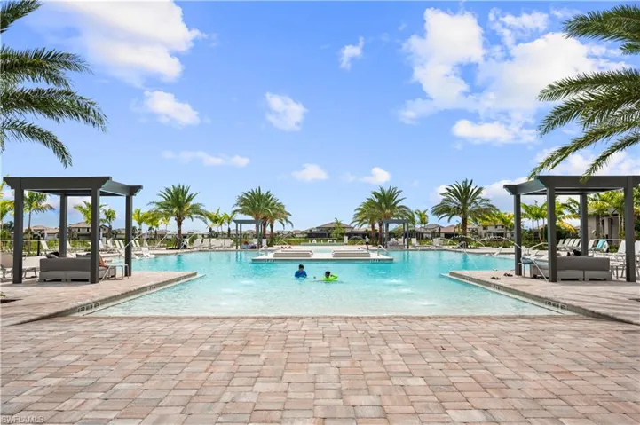 View of community pool featuring zero depth entry