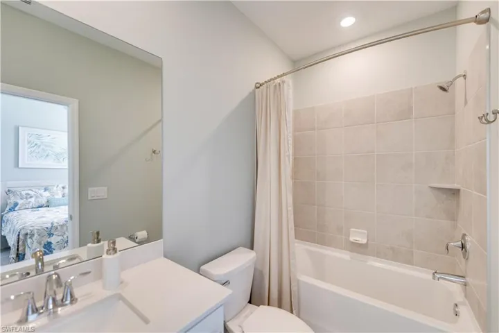 Full bathroom with vanity, toilet, and shower / bath combination with curtain
