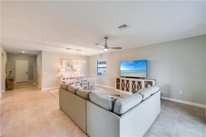 Tiled living room featuring ceiling fan