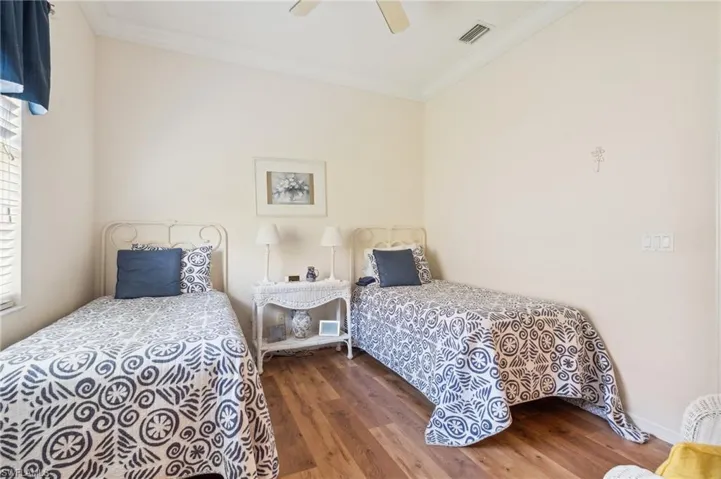 Bedroom featuring crown molding, ceiling fan, and dark hardwood / wood-style floors