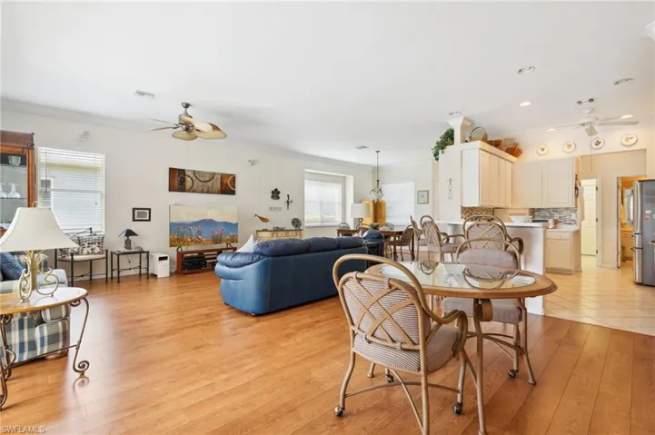 Dining area featuring a wealth of natural light, ceiling fan, and light hardwood / wood-style floors