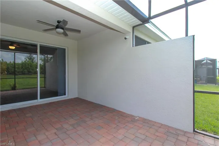 Unfurnished sunroom with ceiling fan