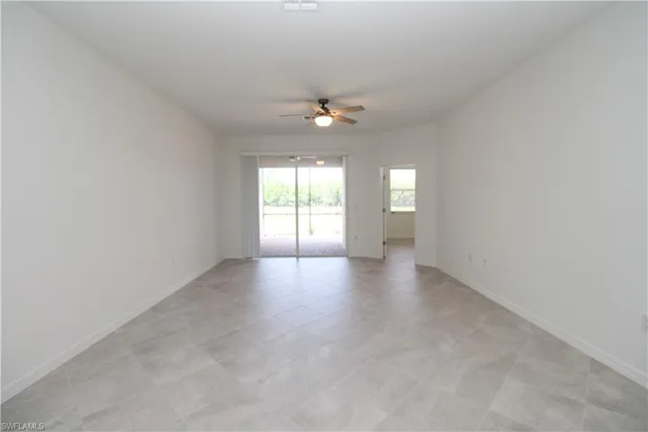 Tiled spare room with ceiling fan