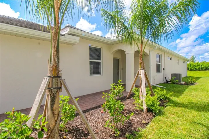 View of front of house with a patio area and a front lawn