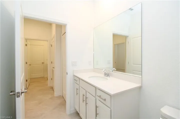 Bathroom featuring tile patterned floors, toilet, and vanity