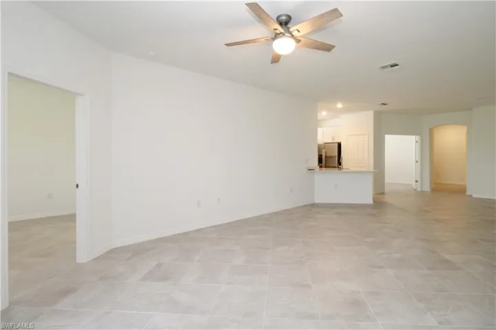 Tiled empty room with ceiling fan