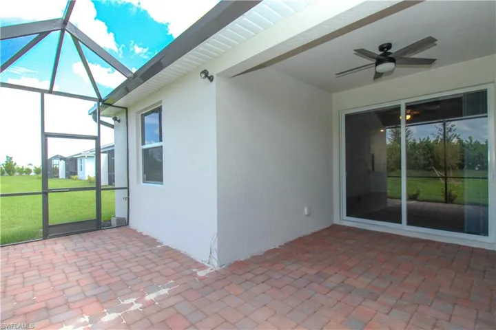 Unfurnished sunroom featuring ceiling fan