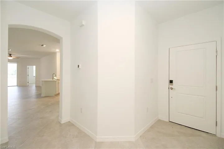 Hallway with light tile patterned floors