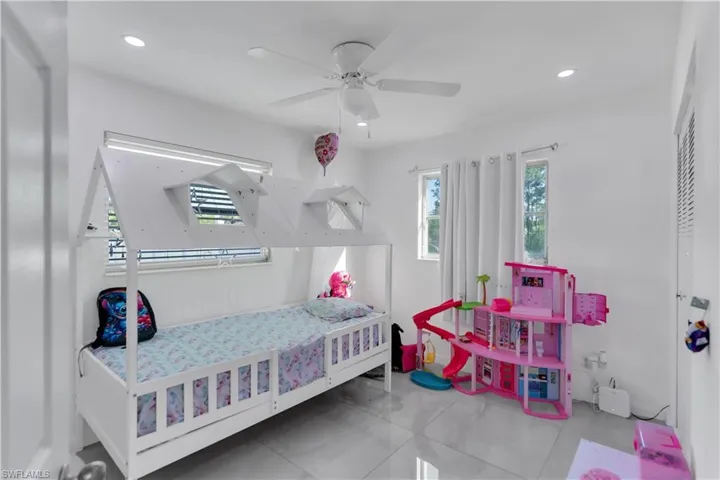 Bedroom with ceiling fan, tile patterned flooring, and recessed lighting