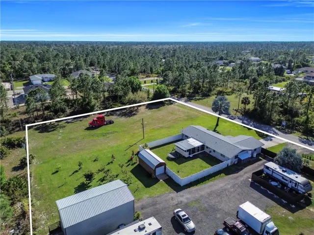 Aerial view featuring a forest view