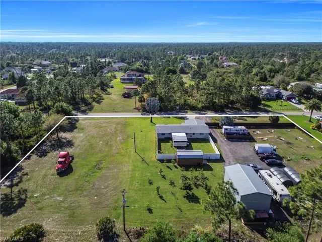 Drone / aerial view featuring a wooded view