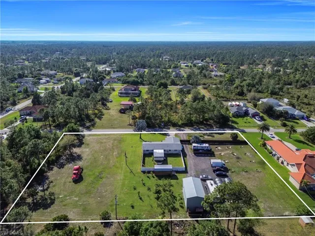 Birds eye view of property with a view of trees