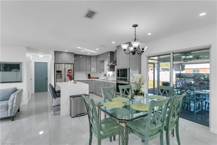 Dining room featuring a chandelier, recessed lighting, visible vents, and light tile patterned flooring