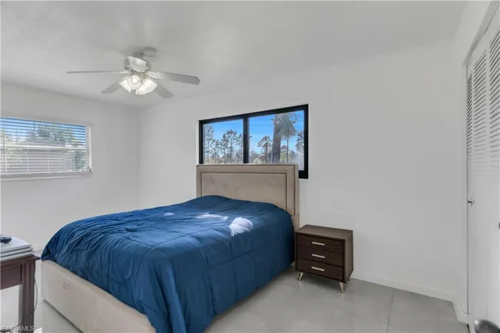 Bedroom with a ceiling fan and baseboards