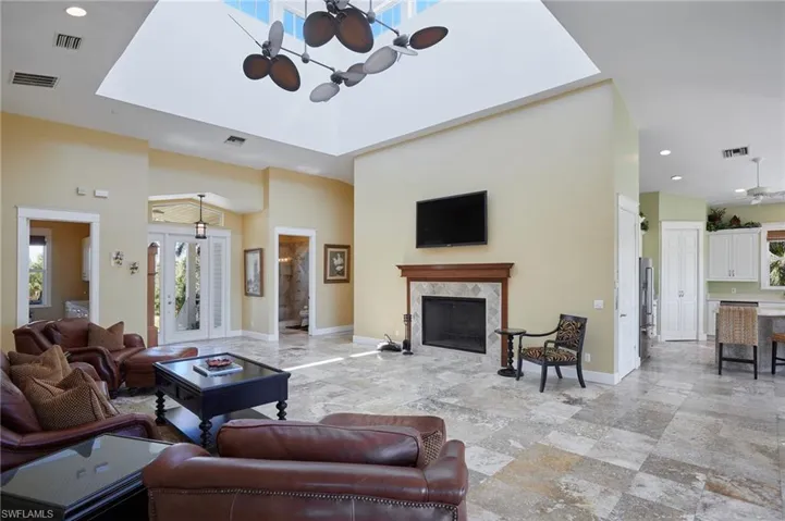 Living area with visible vents, a fireplace, and baseboards