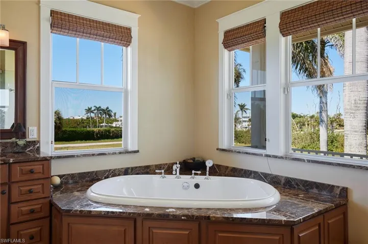 Primary bathroom showing granite tops and beautiful windows for lots of sunlight!